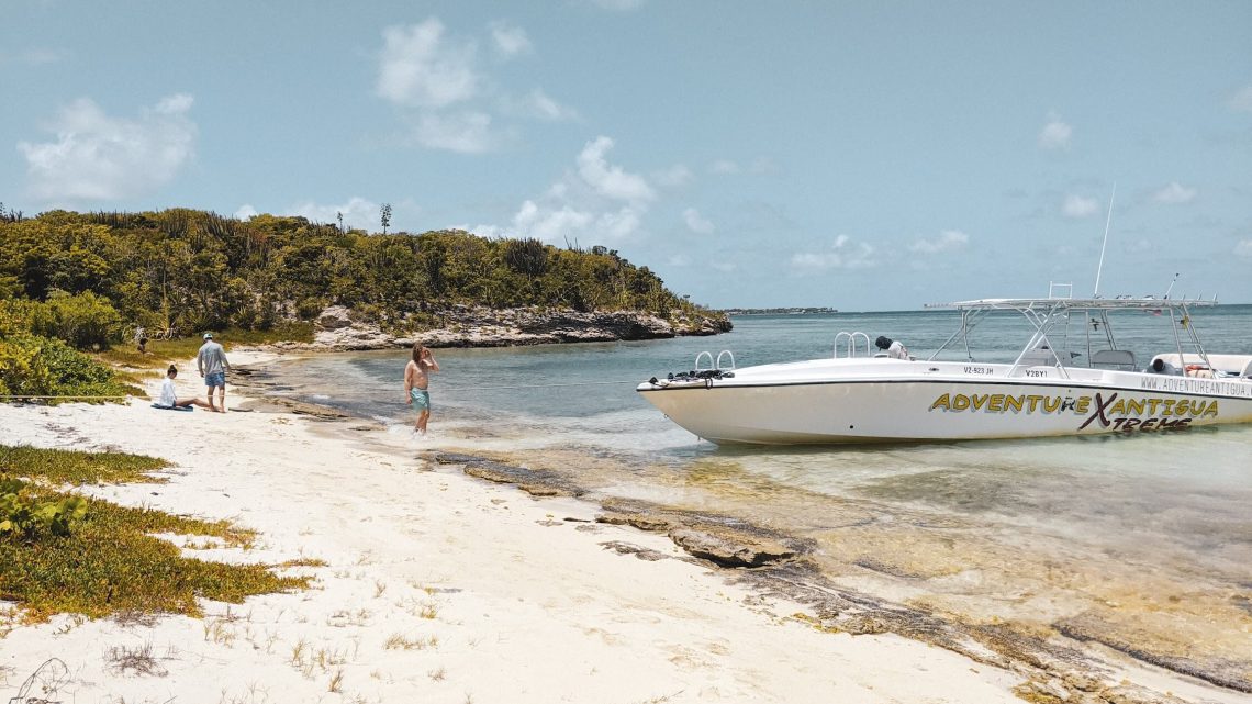 Adventure Antigua boat on white sand beach